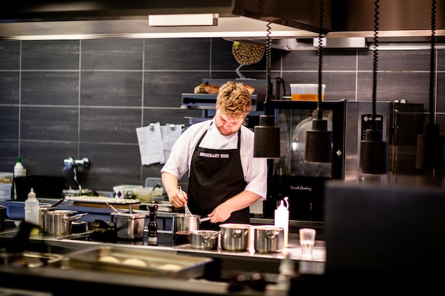 Professional restaurant kitchen with digital compliance tools